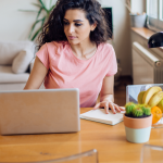 Expat woman working remotely on laptop in home office