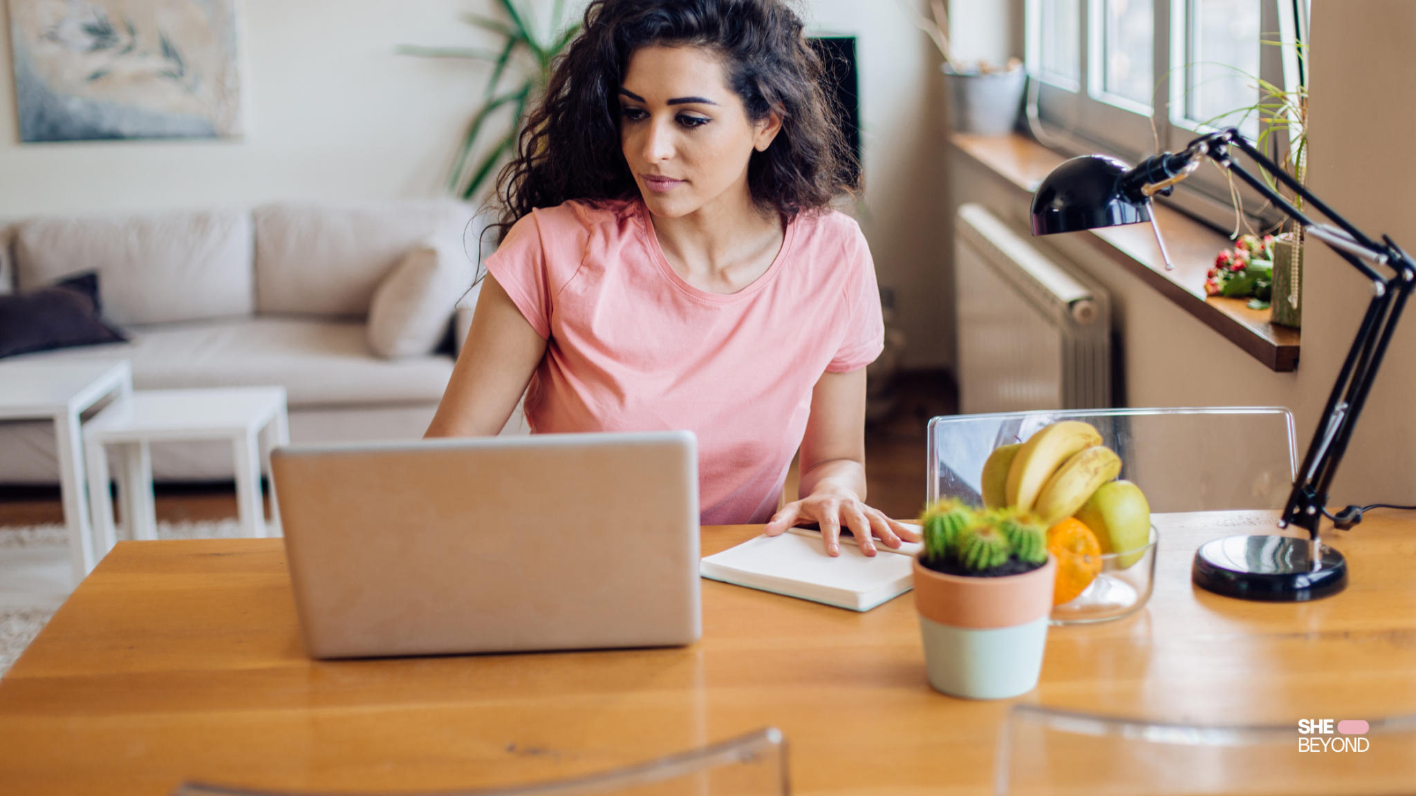 Expat woman working remotely on laptop in home office