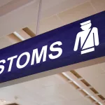 US customs rules sign at border checkpoint for expat partners