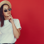 A woman holding a map, thoughtfully planning her next move abroad.
