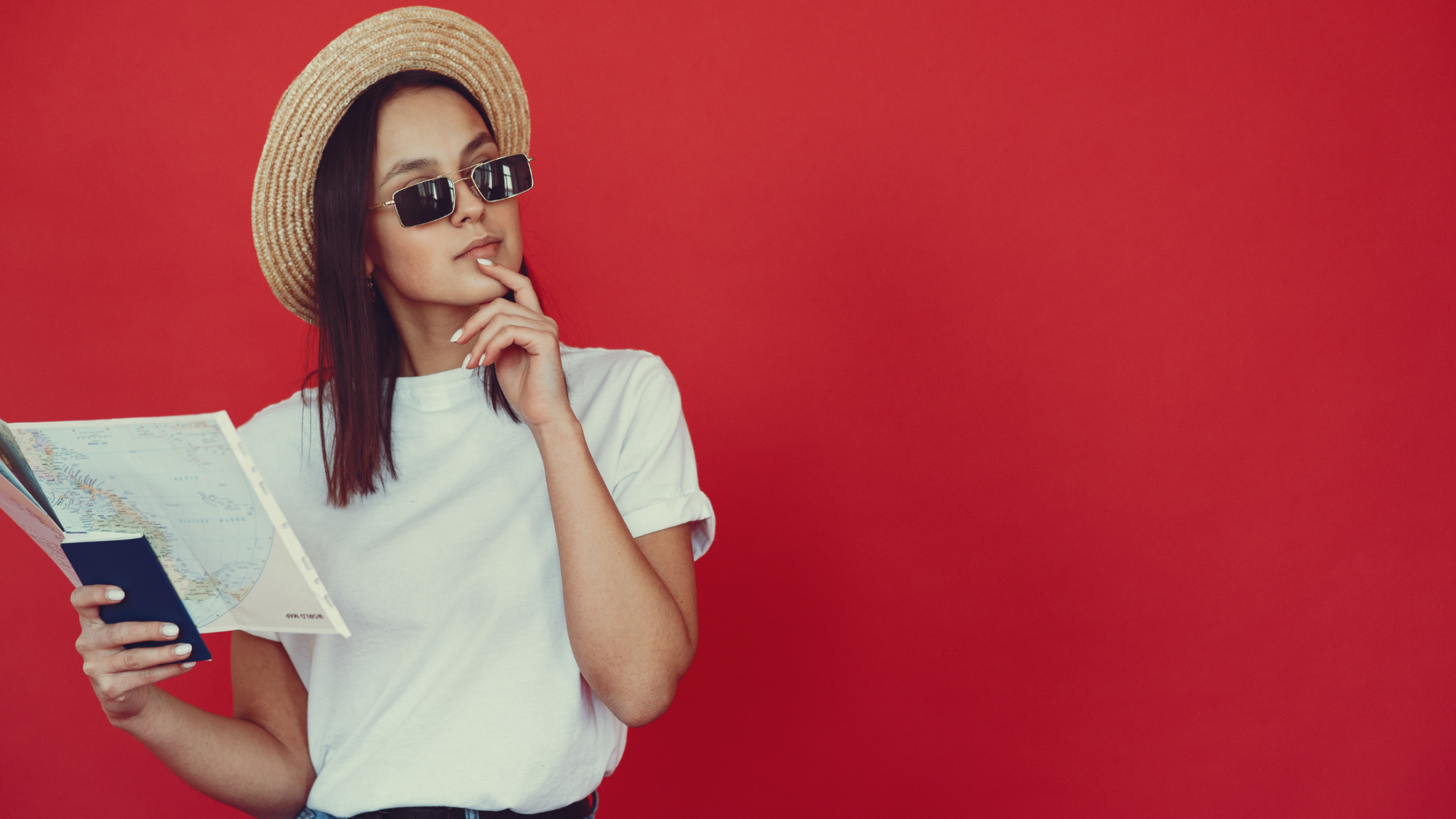 A woman holding a map, thoughtfully planning her next move abroad.
