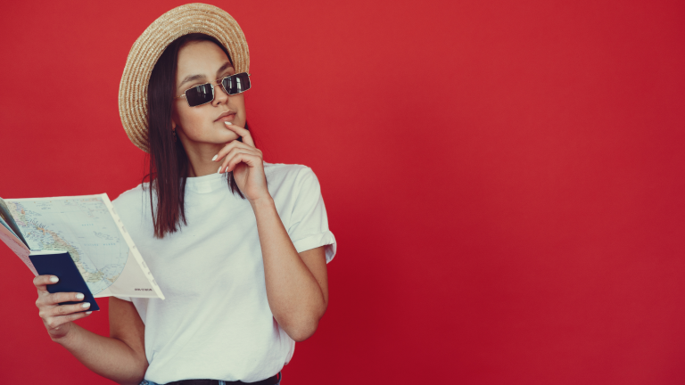 A Woman’s Ultimate Guide to Thriving as an Expat Partner in the USA A woman holding a map, thoughtfully planning her next move abroad.