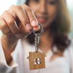 Expat housing U.S. woman holding key to new home
